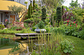 Garden pond with wooden footbridge