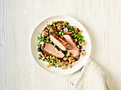 Asian duck breast with peas and mushrooms
