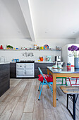 Dining area with various chairs in open-plan kitchen