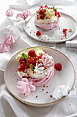 Mini meringue cake with cream, berries and pistachios