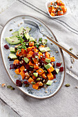 Beetroot, sweet potato and avocado salad sprinkled with seeds