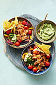 Colourful taco fish bowls with avocado cream (Mexico)