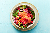 Pink beetroot bowl with spinach, grapefruit and raspberries