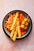 A colourful bowl with three kinds of carrots