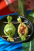 Mexican picadillos wrapped in corn leaves
