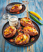 Baked sweet potatoes with bacon and cheese