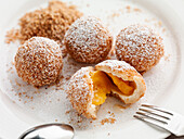 Apricot dumplings with breadcrumbs and icing sugar