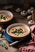 Cream of mushroom soup with butter fried mushroom and parsley