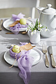 Easter table with colored eggs in a cheesecloth nest
