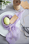 Egg in a muslin cloth nest as Easter table decoration