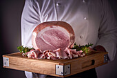 Carved ham on a wooden tray