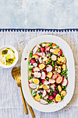 Summer radish and smoked quail egg salad with green peas, radish micro greens and yoghurt Chimichurri dressing