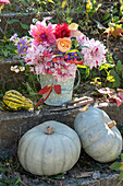Herbststrauß aus Dahlien, Rosen, Astern, Schneebeeren und Samenständen vom Pfaffenhütchen, Speisekürbisse 'Ungarischer Blauer'