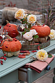 Decoration with rose petals, pumpkins, rose hips and lanterns