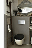 Leiter als Ablage neben Toilette im Bad in Grau mit Vintage-Deko