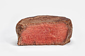 Pink roasted fillet steak on a white background