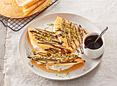 Pumpkin crepes with a cream filling and chocolate sauce