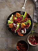 Salad with fried cheese and pomegranate