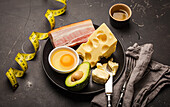 Keto foods as butter, olive oil, fried egg, avocado, fat meat bacon, cheese for ketogenic diet