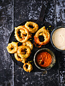Onion rings in beer batter with malt mayo and pepper ketchup