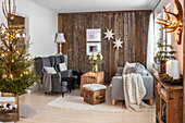 Living room decorated for Christmas with wooden accent wall and Christmas tree