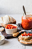 Sweet bell pepper and tomato preserves on bread with cream cheese