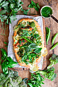 Pizza with broccoli, peas and chicken