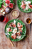 Ruccola salad with figs, ham, and burrata