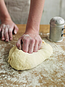 Kneading bread dough on floured surface