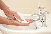 Wiping hands near sink