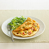 Cheese souffle omelette with sweetcorn, peppers and chives