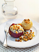 Plate of baked onions stuffed with nuts and cheese