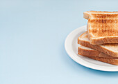 Stack of four slices of toasted white bread