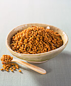 Fenugreek seeds in ceramic bowl and in spoon