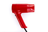 Red plastic hand-held hairdryer