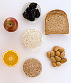Slices of wholegrain bread, prunes, apple, dry grains, nuts