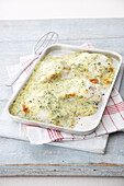 Tray of cod in mustard parsley sauce