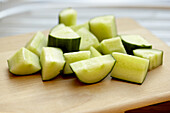 Cucumber chunks on wooden surface