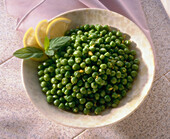 Plate of peas with lemon garnish