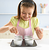 Girl placing white chocolate truffles into moulds