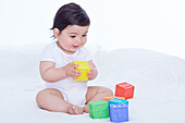 Baby girl playing with stacking cubes