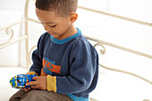 Boy wearing knitted robot jumper