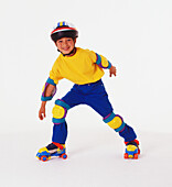 Boy wearing rollerskates, helmet and protective pads