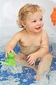 Young girl playing in a bath