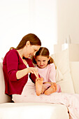 Mother massaging daughter's toe