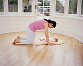 Woman stretching with baby
