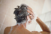 Man taking a shower and washing his hair