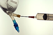 Sodium lactate solution being drawn from a bag into syringe