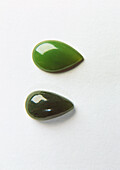 Two nephrite gems cut as droplets