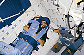 Space shuttle astronaut sleeping